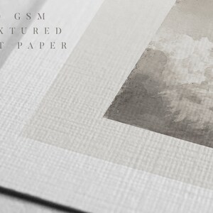 May include: Close-up of a textured white art paper with the text "280 GSM TEXTURED ART PAPER" printed on it. The paper has a subtle grain pattern.