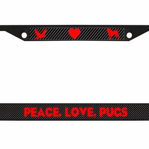 May include: Black license plate frame with red text and graphics. The text reads "PEACE, LOVE, PUCS". The top of the frame has a bird, heart, and pug dog silhouette. The background has a carbon fiber pattern.