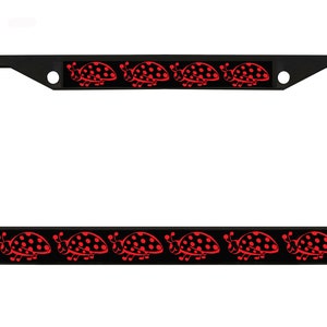 May include: Black license plate frame with a repeating pattern of red ladybugs with black spots. The ladybugs are on a black background, and the frame is rectangular with rounded corners.