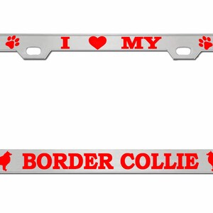 May include: A silver license plate frame with red text and graphics. The top reads "I ❤️ MY" with paw prints and bone graphics. The bottom reads "BORDER COLLIE" with a dog silhouette.