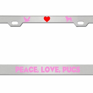 May include: Silver license plate frame with a pink bird, red heart, and pink pug silhouette. The text "PEACE, LOVE, PUGS" is printed in pink on the bottom.