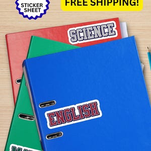 May include: A sticker sheet featuring five individual stickers with academic subject labels. The stickers display the words SCIENCE in grey and blue, ENGLISH in red and blue, and MATH in green and blue, all in a bold, collegiate-style font.