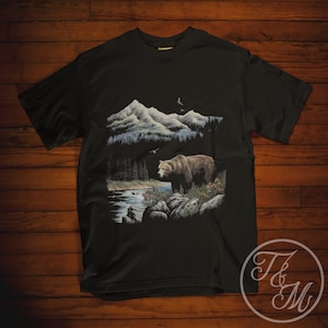 Vintage Style Grizzly Bear next to River Graphic Design on Unisex Classic Black Heavy Cotton T-Shirt