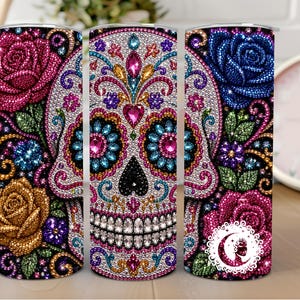 May include: A cylindrical tumbler featuring a vibrant diamond-art style design of a sugar skull surrounded by colorful roses in shades of pink, blue, and gold. The surface is covered in a mosaic of sparkling, multi-colored gems and intricate patterns.