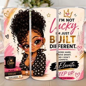 May include: A cylindrical tumbler featuring a cartoon illustration of a person with curly hair and glasses, wearing a polka dot shirt. Text reads: I'M NOT LUCKY. I'M JUST BUILT DIFFERENT. WORK HARD, MOVE SMART, AND I DON'T COMPETE... I ELEVATE. KEEP UP.