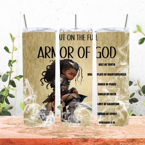 May include: A 20 oz tumbler with a design featuring a kneeling warrior in armor. The tumbler has the words "ARMOR OF GOD" and a list of spiritual armor components. The background is a light beige with a smoky effect.