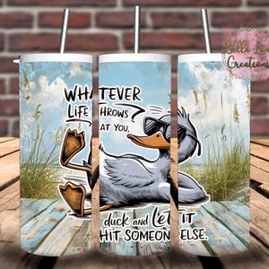 May include: A white tumbler with a blue sky and beach scene. A cartoon duck wearing sunglasses is on the beach with the text "WHATEVER LIFE THROWS AT YOU, DUCK AND LET IT HIT SOMEONE ELSE."