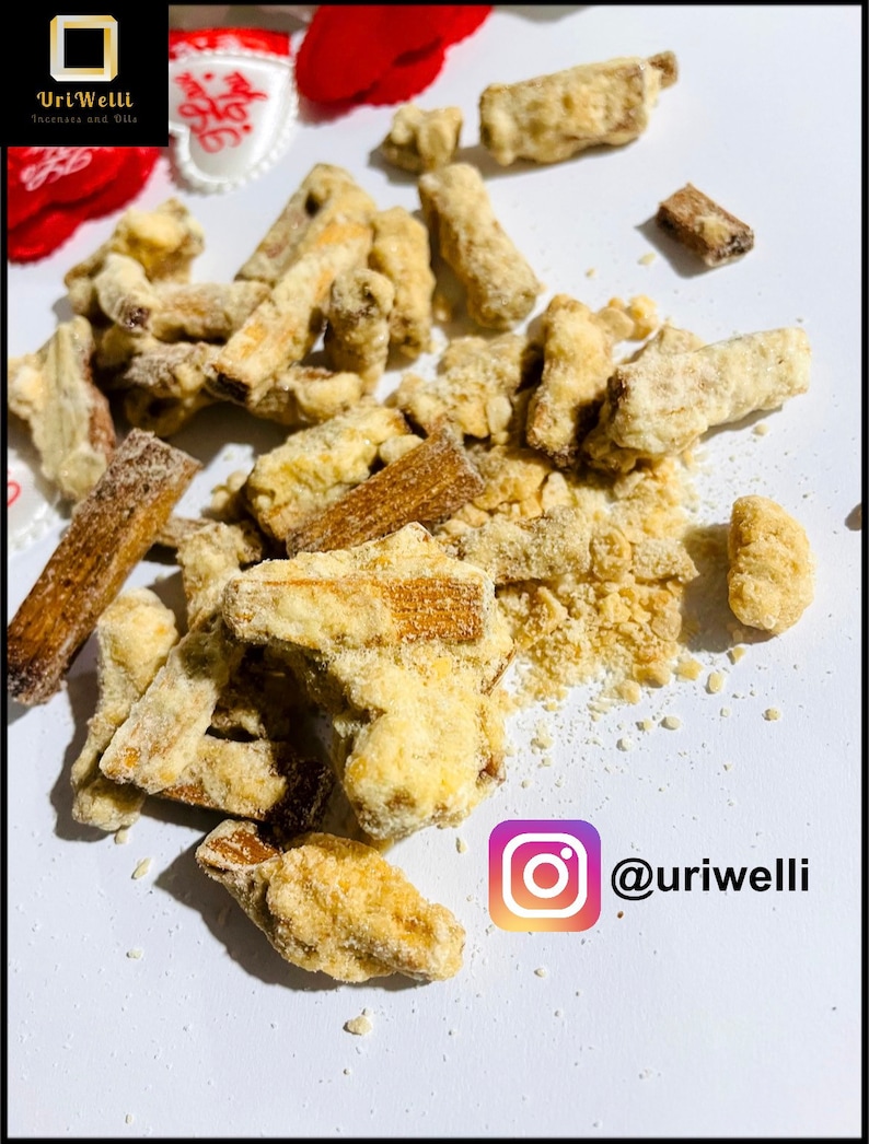 May include: A close-up of a pile of crunchy, golden brown, sugar-coated snacks. The snacks are scattered on a white surface. The Instagram handle @uriwelli is visible in the lower right corner of the image.