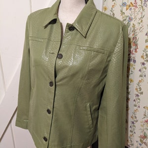 May include: A green faux leather jacket with a button-up front and a snakeskin pattern.