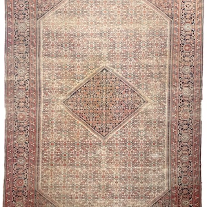 Puede incluir: Una alfombra persa vintage con fondo crema y intrincados patrones geométricos en tonos rojos, azules y marrones. La alfombra tiene un gran medallón en forma de diamante en el centro y un borde con motivos florales.