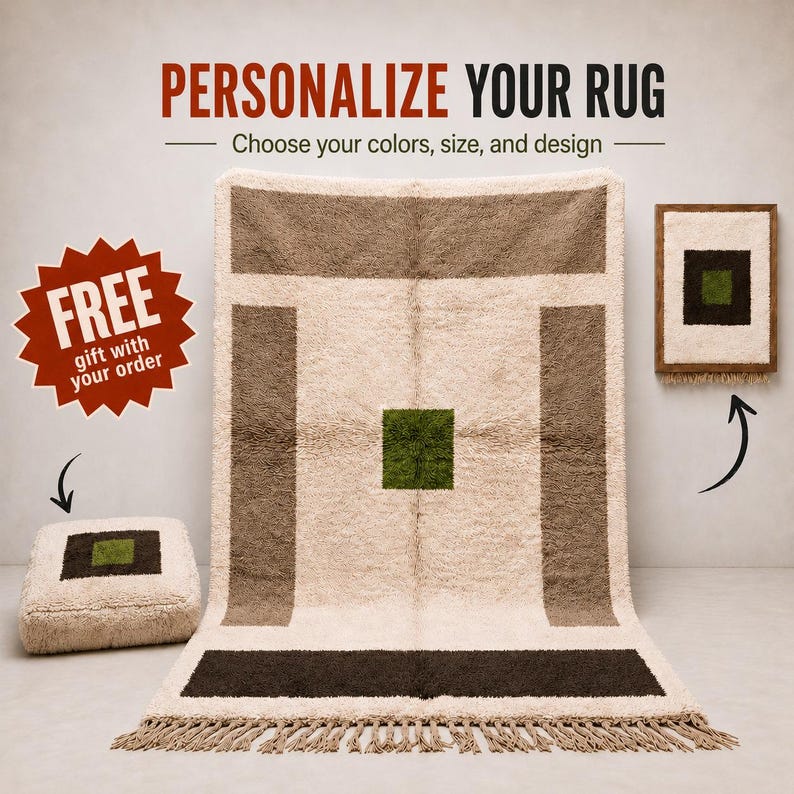 May include: A large, rectangular, cream-colored shag rug with brown and dark green geometric accents and a fringed edge. The rug is displayed alongside a matching square floor cushion and a framed wall art piece, all featuring similar patterns.