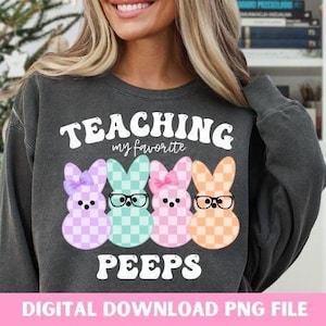 May include: A gray sweatshirt with the text "TEACHING my favorite PEEPS" in a retro font. Three cartoon Peeps, one pink, one green, and one orange, are wearing glasses and are arranged in a row below the text.