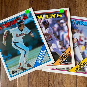 May include: Three baseball cards featuring players from the Angels, Twins, and Tigers. The cards are in mint condition and feature colorful graphics with the team logos and player names.