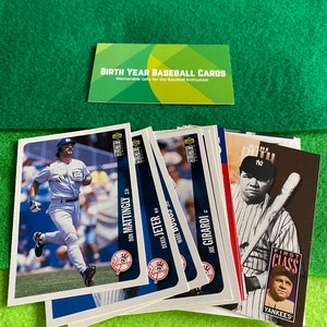 May include: A collection of baseball cards featuring players from the New York Yankees. The cards are from the 1990s and feature players like Don Mattingly, Derek Jeter, Wade Boggs, and Joe Girardi. The cards are in good condition and have a blue and white color scheme.