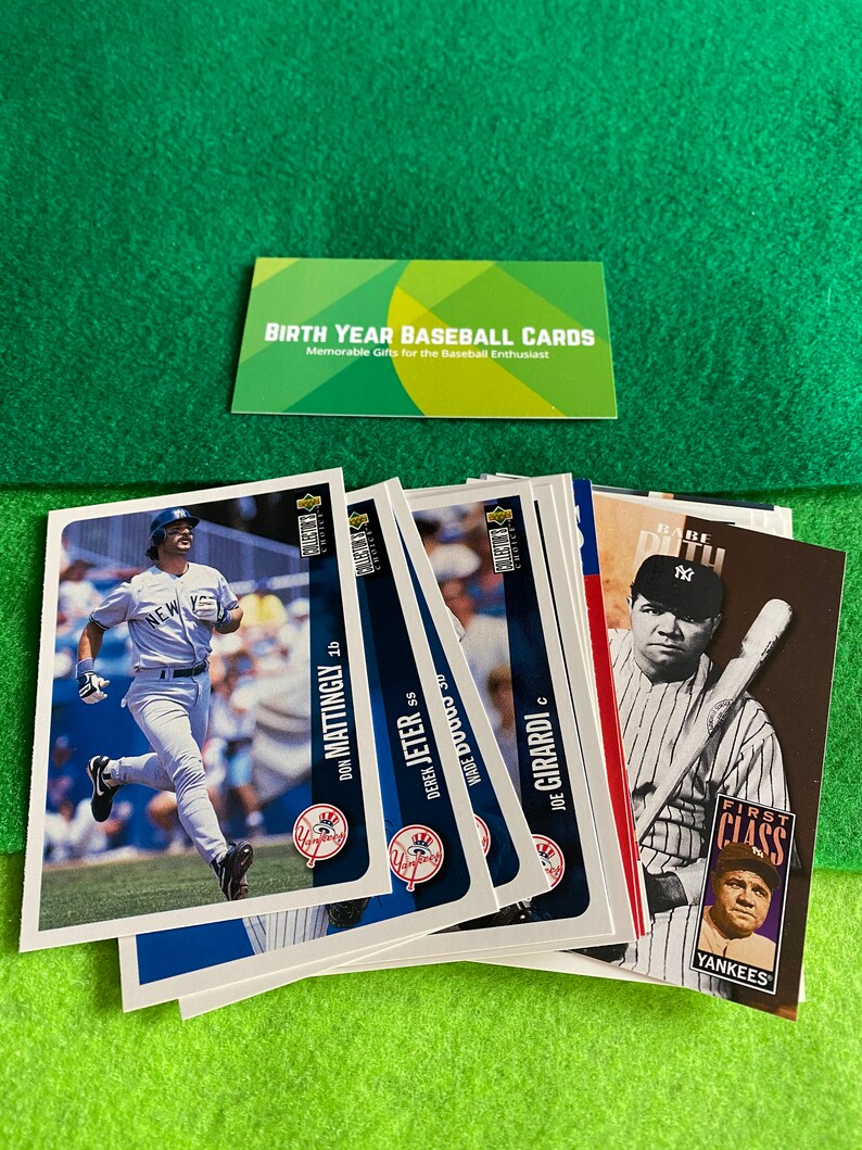 May include: A collection of baseball cards featuring players from the New York Yankees. The cards are from the 1990s and feature players like Don Mattingly, Derek Jeter, Wade Boggs, and Joe Girardi. The cards are in good condition and have a blue and white color scheme.