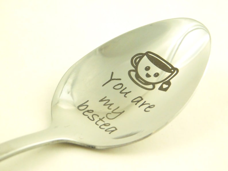 May include: A silver spoon with the words "You are my bestea" engraved on it. A cartoon teacup with a smiley face is also engraved on the spoon.