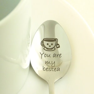 May include: A silver spoon with the text "You are my bestea" and a cartoon image of a teacup with a smiling face and a tea bag.