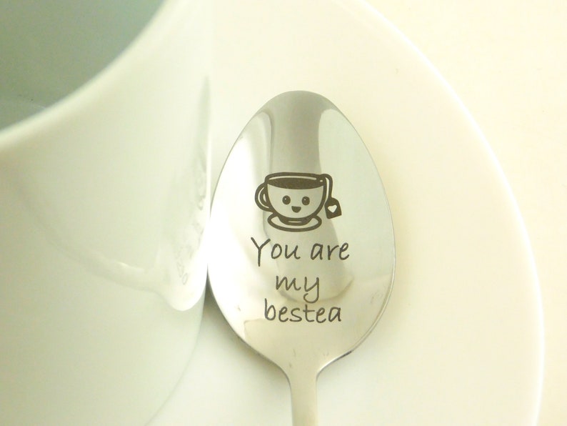 May include: A silver spoon with the text "You are my bestea" and a cartoon image of a teacup with a smiling face and a tea bag.
