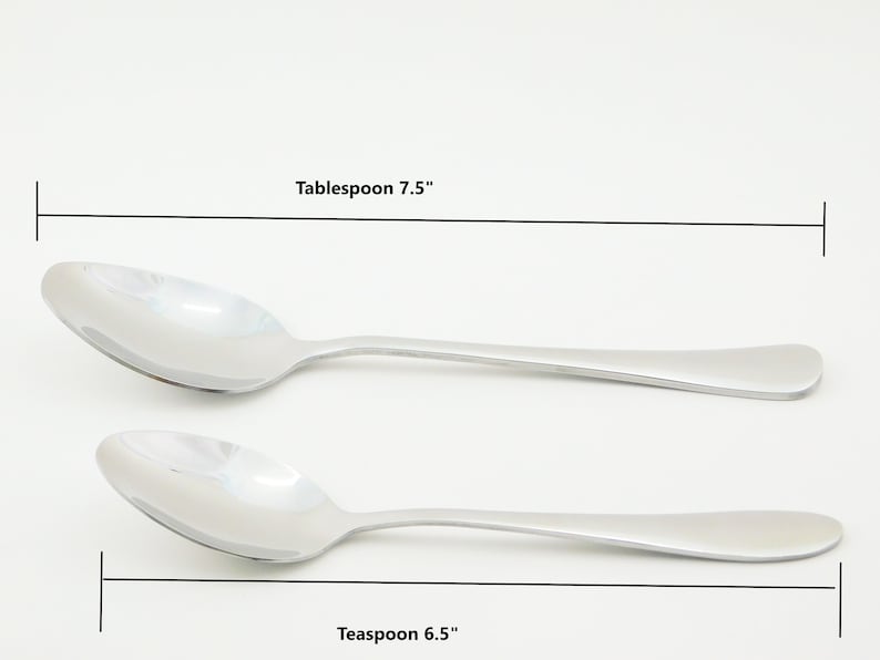 May include: Two silver spoons, one measuring 7.5 inches and labeled "Tablespoon" and the other measuring 6.5 inches and labeled "Teaspoon".