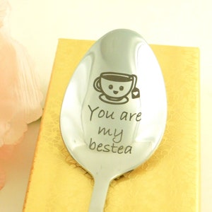 May include: A silver spoon with a smiling teacup and the text "You are my bestea" engraved on it.