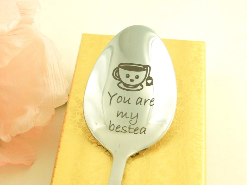 May include: A silver spoon with a smiling teacup and the text "You are my bestea" engraved on it.