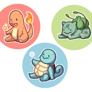 May include: Three cartoon characters from the Pokemon franchise. A red and orange Charmander, a green Bulbasaur, and a blue Squirtle.