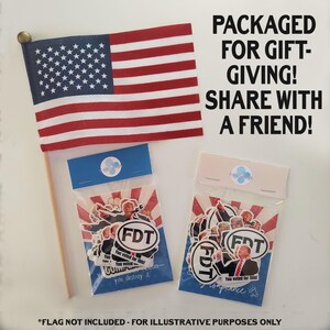 May include: An American flag with red and white stripes and a blue field of white stars. Two packages of stickers with the text "FDT" and "You voted for this!" are displayed. Text reads "PACKAGED FOR GIFT-GIVING! SHARE WITH A FRIEND!"