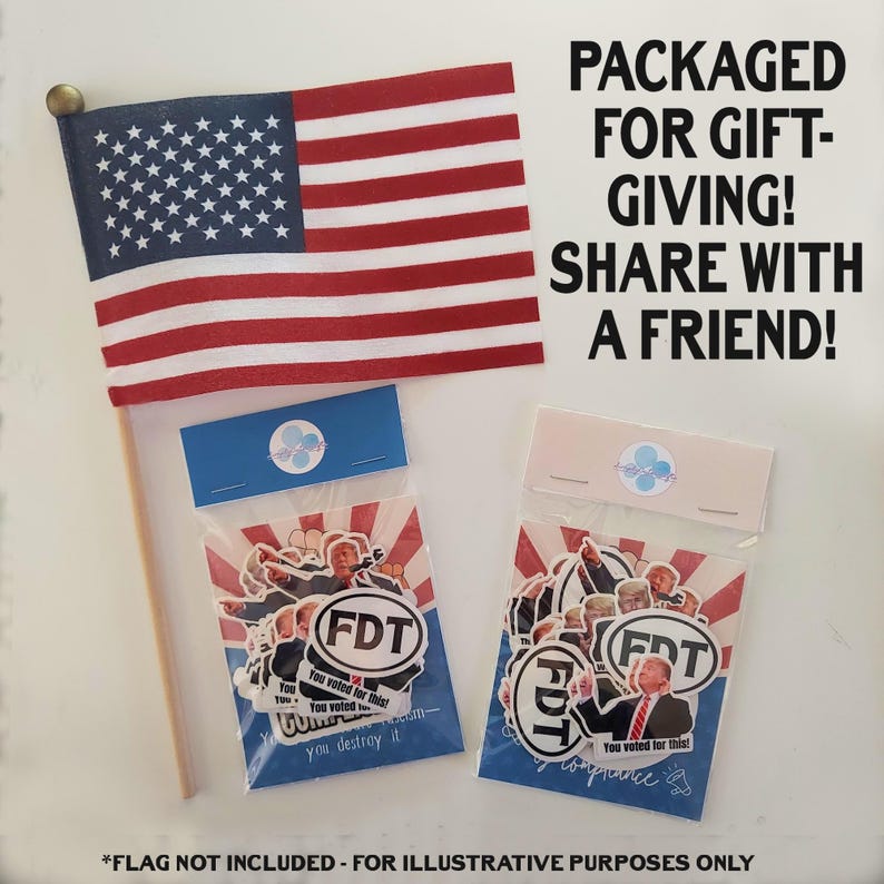 May include: An American flag with red and white stripes and a blue field of white stars. Two packages of stickers with the text "FDT" and "You voted for this!" are displayed. Text reads "PACKAGED FOR GIFT-GIVING! SHARE WITH A FRIEND!"