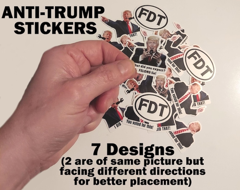 May include: A collection of anti-Trump stickers with various designs. The stickers feature images of Donald Trump with the text "FDT" and other phrases. The text "ANTI-TRUMP STICKERS" and "7 Designs" are also visible.