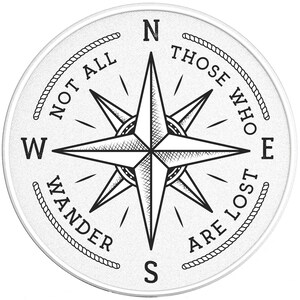 May include: A white compass with a black compass rose and the text "Not all those who wander are lost" around the edge.