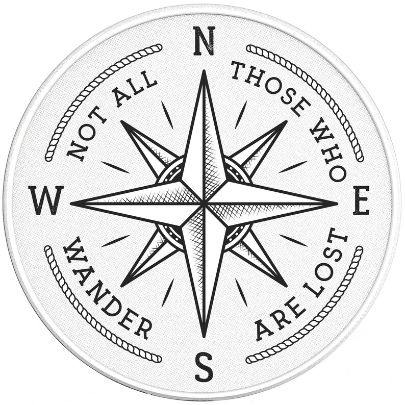 May include: A white compass with a black compass rose and the text "Not all those who wander are lost" around the edge.
