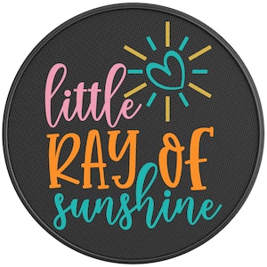 May include: A round black doormat with the text "little ray of sunshine" in pink, orange, and blue lettering. A yellow sun with a pink heart in the center is above the text.