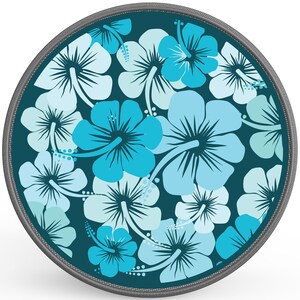 May include: A round, teal blue fabric coaster with a repeating pattern of light blue and turquoise hibiscus flowers.