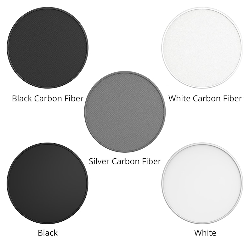 May include: Four round phone grips with different finishes: black carbon fiber, silver carbon fiber, white carbon fiber, and black. The grips are all the same size and shape.