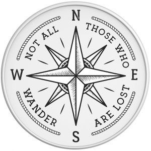 May include: Black and white compass with a star design and the text "Not all those who wander are lost" around the edge.