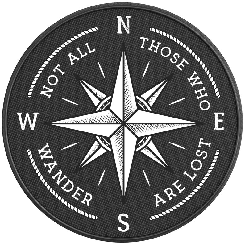 May include: Black and white compass with a white star in the center and the text "Not all those who wander are lost" around the edge.