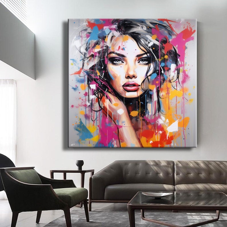 May include: A colorful abstract painting of a woman's face with splashes of pink, blue, yellow, and orange paint.