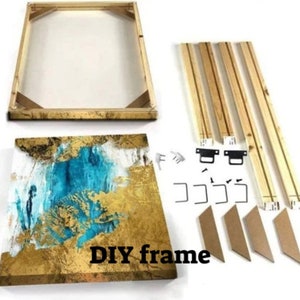May include: A DIY frame kit for a canvas painting. The kit includes four wooden frame pieces, four corner connectors, four metal hanging brackets, and four cardboard corner pieces. The canvas painting is a gold and blue abstract design.