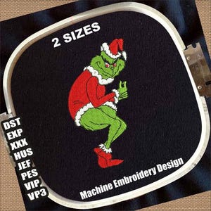 May include: Machine embroidery design featuring a green character in a red Santa suit and hat, with white trim. The design is on black fabric, with the text "2 SIZES" and "Machine Embroidery Design".