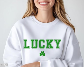 May include: White sweatshirt with the word "LUCKY" printed in green block letters. A green shamrock is below the word.
