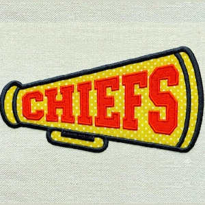 May include: A megaphone-shaped embroidered patch featuring a yellow background with a white polka dot pattern. The word CHIEFS is stitched in bold red block letters across the center. The entire patch is outlined with a thick black border.