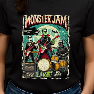 May include: Black t-shirt featuring a graphic of a band called "Monster Jam" with Frankenstein and other monster characters playing instruments. The design includes the text "The Crypt Club", "Frankenstein Monster", and "Live One Night".