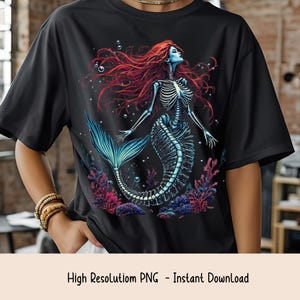 May include: Black t-shirt featuring a skeletal mermaid design with red hair, a blue face, and a blue tail. The mermaid is surrounded by coral and bubbles. The text "High Resolution PNG - Instant Download" is at the bottom.