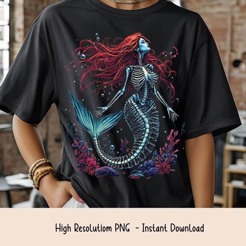 May include: Black t-shirt featuring a skeletal mermaid design with red hair, a blue face, and a blue tail. The mermaid is surrounded by coral and bubbles. The text "High Resolution PNG - Instant Download" is at the bottom.