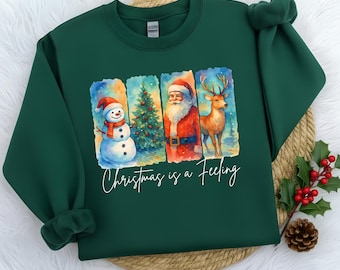 Christmas is a Feeling T-Shirt – Festive Holiday Shirt with Snowman, Santa, Reindeer & Tree – Cute Christmas Graphic Tee |Oversized Crewneck