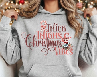 Funny “Thick Thighs & Christmas Vibes” shirt, crewneck, or hoodie, sizes S–3XL.