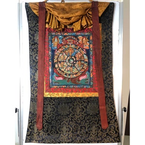 Wheel of life thangka painting. hand painted wheel of life with tibetan traditional brocade. for shrine. samsara and nirvana, bhavachakra.