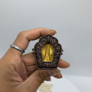 24 k gold plated thousand armed Dukkar Tsatsa with traditional ghau box. handmade tibetan style pendant. protection from spirits, bad omens.