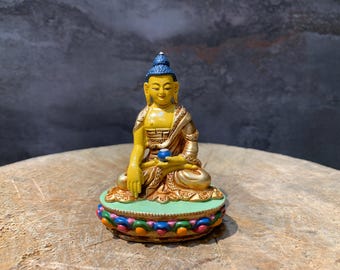 Hand crafted colorful Buddha statue. copper statue. Shakyamuni Buddha. Buddha the enlightened one. for good luck.