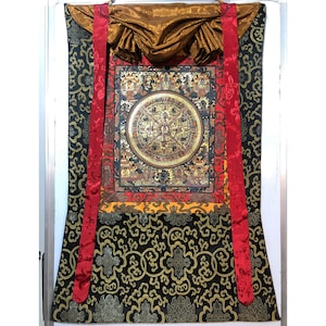 Detail buddha mandala thangka painting with traditional brocade. smoky colored mandala thangka. tibetan brocade. hand painted mandala art